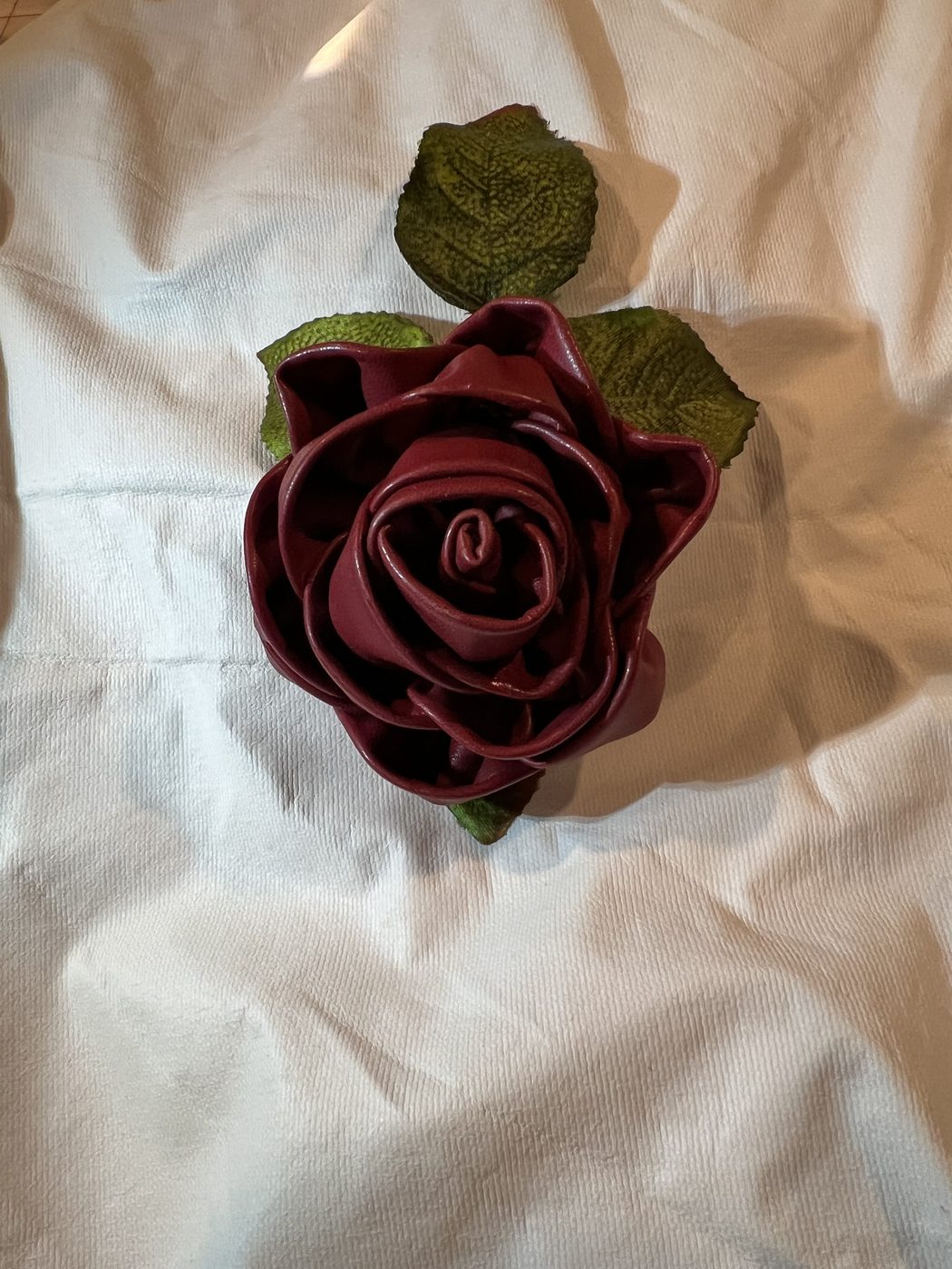 Handmade burgundy ribbon rose with leaves